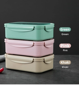 Three-layer stacked bento boxes in green, pink, and khaki with snap-lock lids