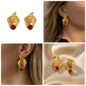 Detail showing gold conch tassel earrings with red zircon in a four-grid layout
