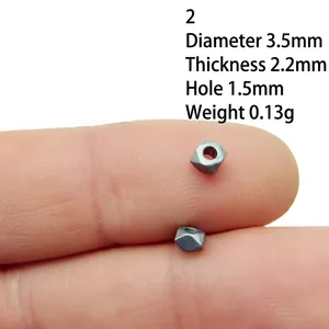 Macro detail of 3.5mm silver alloy bead spacer held on finger for size reference