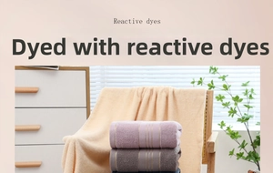 Detail of soft cotton towels in pink, purple and grey with elegant gold stripe accents