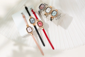 Close-up of elegant oval women watches with crystal-set bezels and colorful leather straps