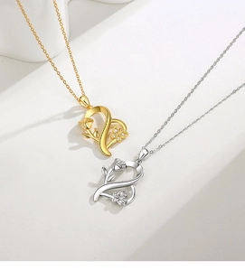 Close-up of S925 silver heart necklaces featuring rose and butterfly details in gold and silver