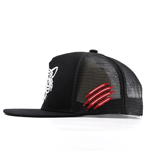 Detail of tiger embroidery and mesh back on a black hip-hop trucker baseball cap