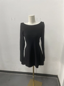 Detail of elegant black knitted mini dress showing slim fit silhouette and long sleeves