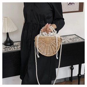 Detailed shot of handmade bamboo bag featuring large pearl handle and drawstring lining