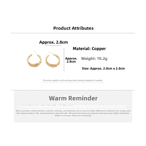 Detail view of gold twisted metal hoop earrings showing material size and weight specs