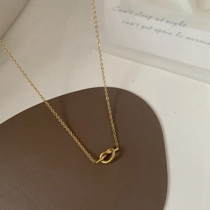 Minimalist 18K gold plated titanium steel necklace with knot pendant and toggle clasp
