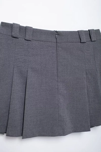 Detail view of grey pleated skirt back showing belt loops and hidden zipper closure