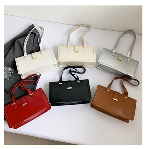 Close-up of minimalist square underarm bags in six colors with gold metal locks