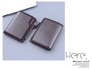 Detail view of brown leather wallet showing the smooth texture and silver metal zipper