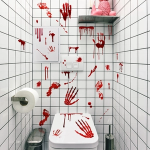 Macro shot of realistic red blood handprint and footprint decals on bathroom tiles
