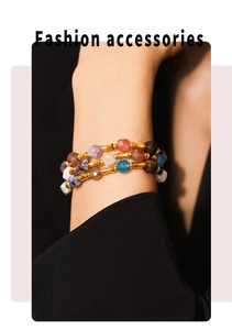Detail of colorful gemstone beads and gold-plated stainless steel layered bracelet