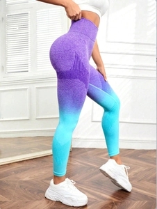 Detail of high-waisted seamless yoga leggings with purple to blue gradient and butt-lift texture