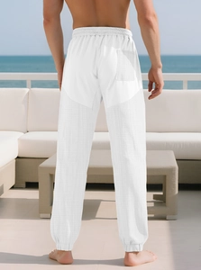 Rear view of men's white waffle texture casual pants on a bright seaside terrace