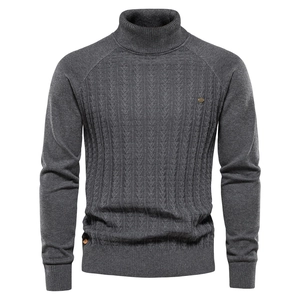 Detail of dark grey turtleneck sweater featuring intricate vintage cable knit texture