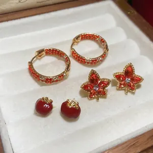 Gold-plated earrings set featuring maple leaf, red persimmon, and zircon hoop designs