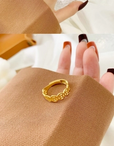 Macro shot of 18K gold plated adjustable ring with traditional Chinese coin pattern
