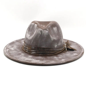 Detail of vintage brown wool felt hat with distressed texture and leather band decoration