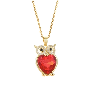 Golden owl pendant necklace featuring a large red heart-shaped crystal and sparkling accents