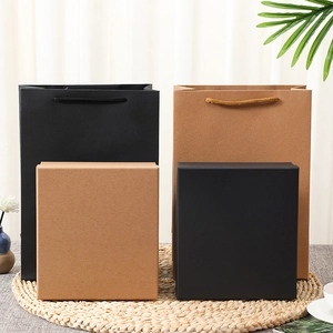 Minimalist black and kraft paper gift boxes with matching bags for elegant packaging