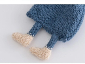 Detailed macro view of soft blue knit texture and creamy white yarn stitching on baby scarf