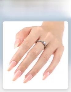Detail of short almond nails in gradient nude orange with elegant jelly texture finish