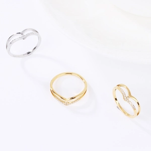 Elegant V-shaped rings in gold and silver finish with sparkling rhinestones on white background