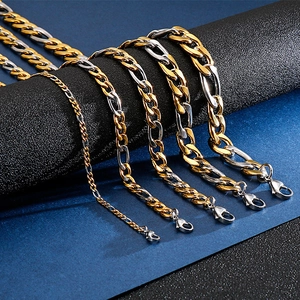 Macro view of two-tone gold and silver Cuban link chains with lobster clasps for men