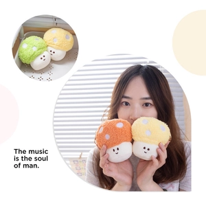 Close-up of cute plush mushroom keychains in green yellow and orange curly fur texture