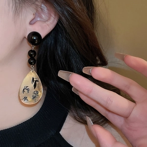 Detail of New Chinese style earrings with painted water drop pendants on model