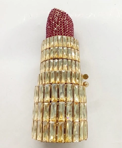 Macro shot of lipstick-shaped clutch evening bag featuring intricate rhinestone inlay