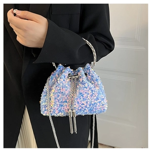 Detail of iridescent sequin bucket bag with metal handle and chain strap for women