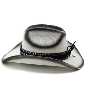 Detail of woven straw cowboy hat with metallic bull rivets and vintage gradient texture