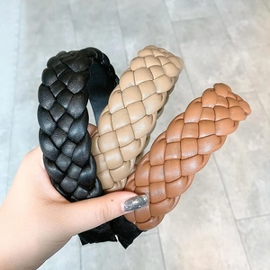 Detailed texture of braided PU leather headbands in black, khaki, and brown colors
