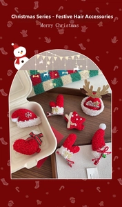Detailed view of plush Christmas hair clips with reindeer antlers and star decorations