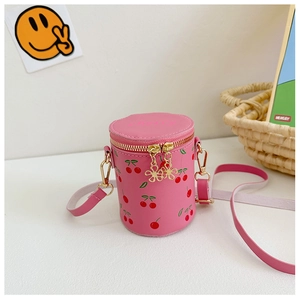 Close-up of pink cherry print bucket bag with golden flower zipper and pink strap