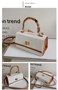 Detail of retro crocodile pattern bag featuring authentic bamboo handle and gold lock