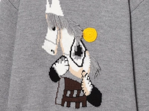 Detailed view of white horse embroidery and knit texture on grey wool sweater