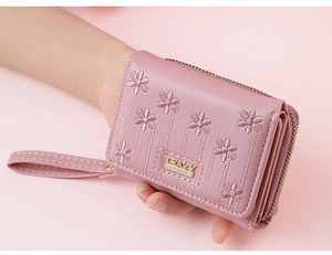 Detail of pink PU leather short wallet featuring floral embroidery and metal zipper strap