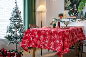 Detail view of red Christmas tablecloth with snowflake patterns in a cozy holiday home setting