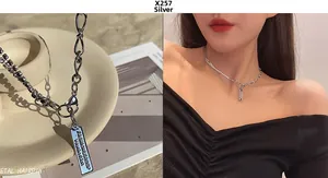 Detail of silver patchwork chain necklace with sparkling crystals and metal pendant