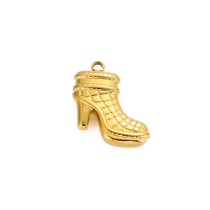 Detailed macro view of a golden high heel stiletto pendant with grid texture and metal ring