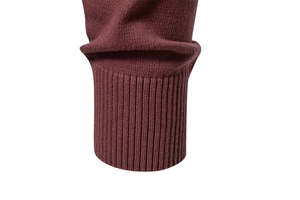 Close-up of ribbed cuffs on a men's burgundy cotton knit sweater with fine stitching