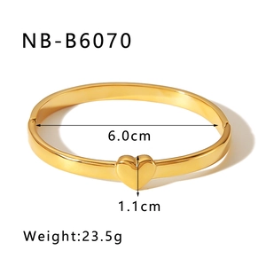 Detailed view of gold heart bangle with 6.0cm inner diameter and 23.5g weight specs