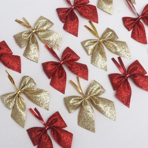 Macro detail of red and gold glitter Christmas bows with wire ties for festive decor