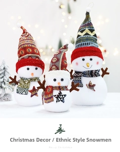 Three plush snowmen in ethnic knit hats and scarves for festive Christmas decor