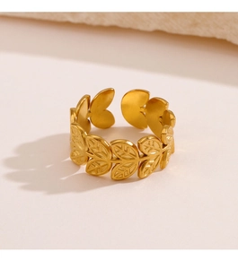 Macro detail of golden olive leaf ring with textured matte finish and adjustable band