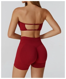 Detail of red seamless sports bra with hollow back design and high waist yoga shorts