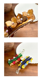 Detailed close-up of acetate banana hair clips with rhinestones and flower designs