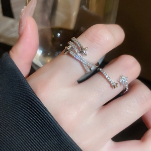 Macro shot of star-shaped adjustable rings with sparkling zircon pavé on model's hand